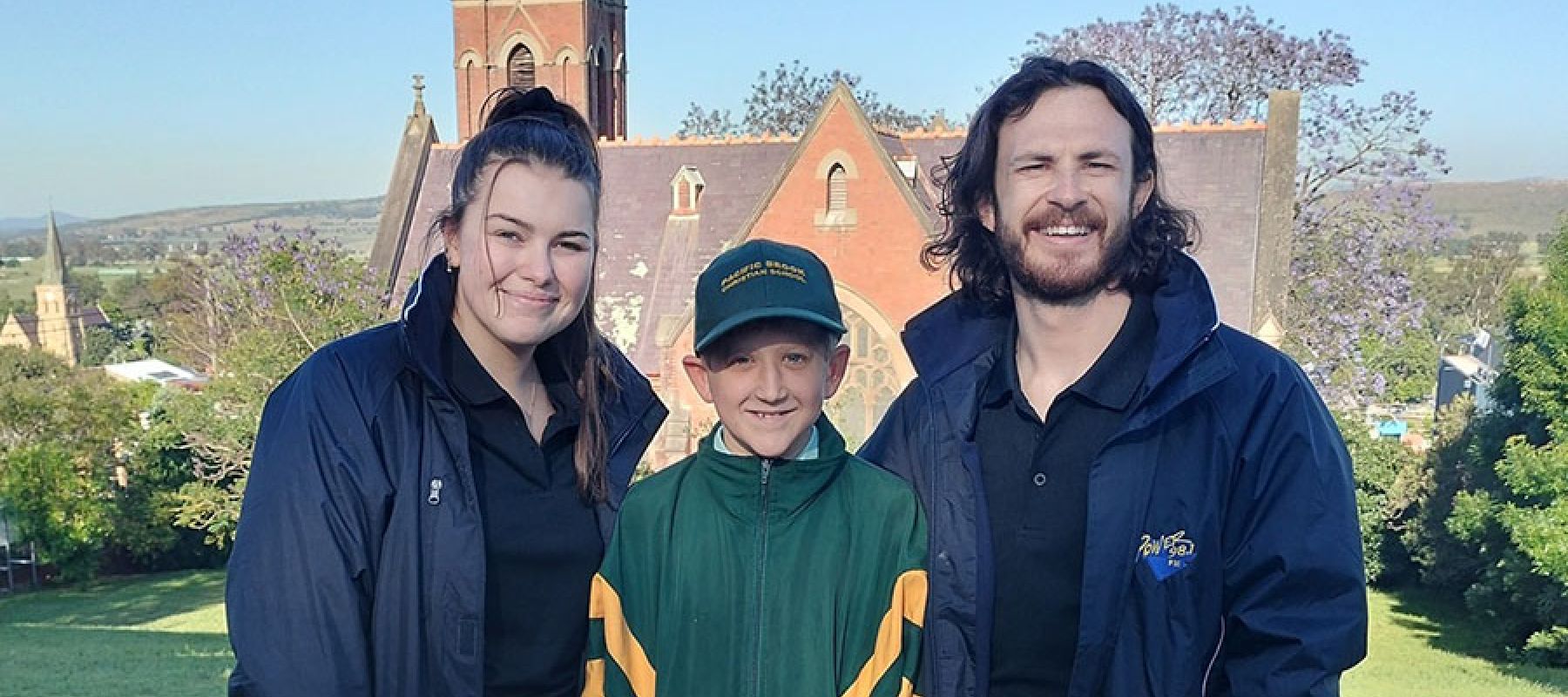 student with local radio station hosts who visited the school